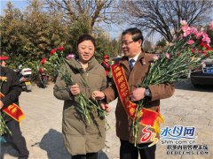 志愿者发放鲜花倡导文明祭祀